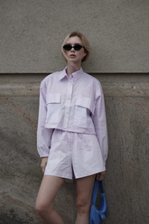 a lady in a pink lapel shirt and a pair of pink shorts